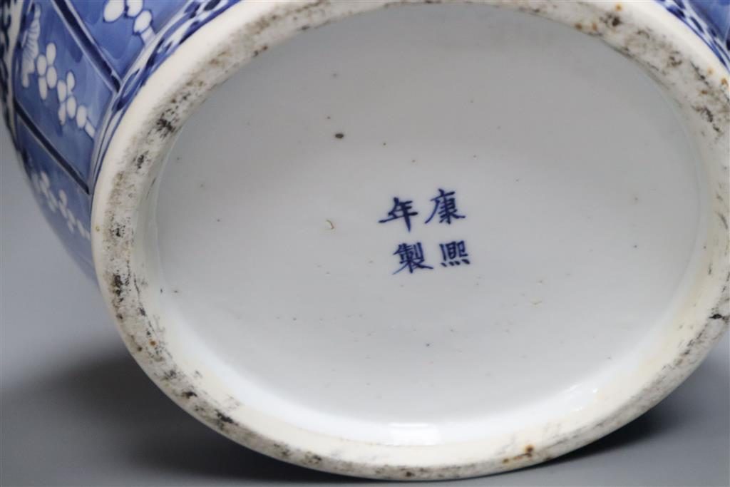 A 19th century blue and white water jar and cover, painted with dragons and birds, with inner cover and two later jars and covers